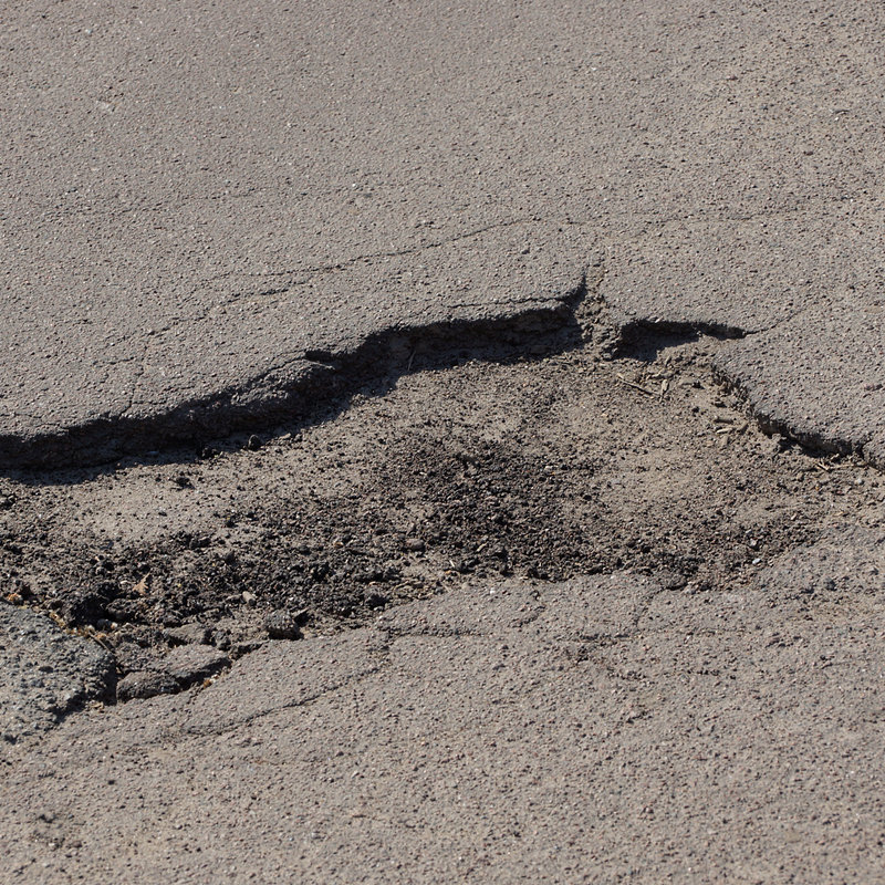 close-up of a pothole on an asphalt road