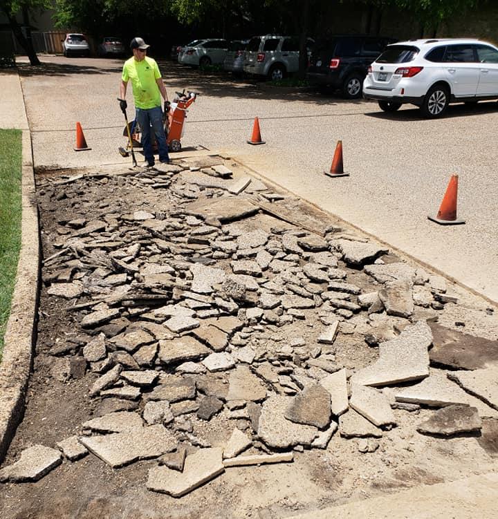 Employee Busting Concrete for Replacement