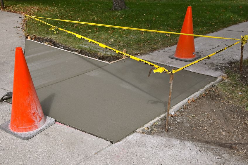 Cones and Caution Tape Around a Finished Concrete Project.