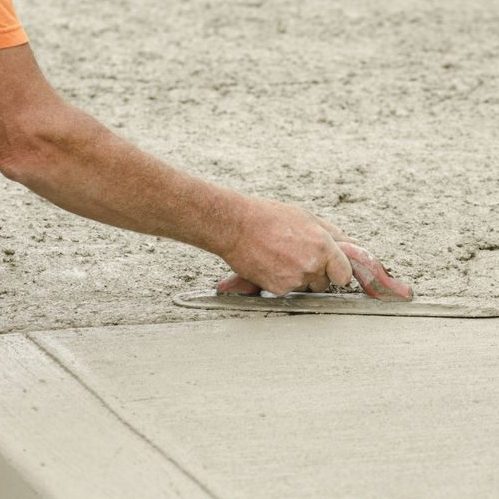 A Picture of a Contractor Installing New Concrete Sidewalk.