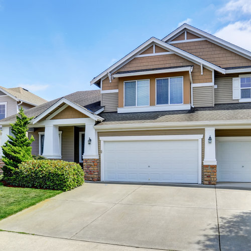 Classic American two level house exterior with siding trim and garage. Northwest, USA