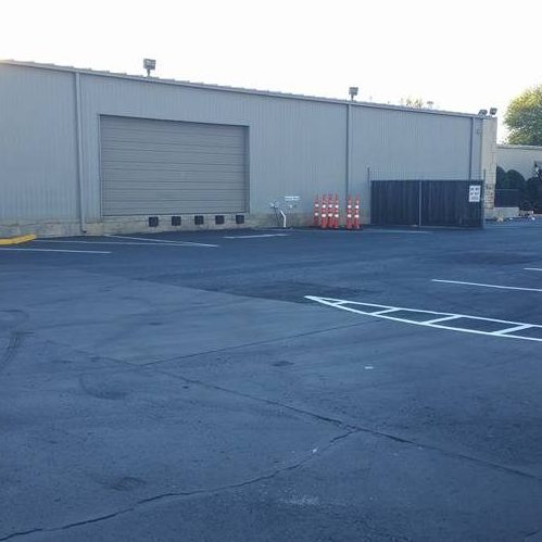 A Picture of a Parking Lot of a Warehouse.