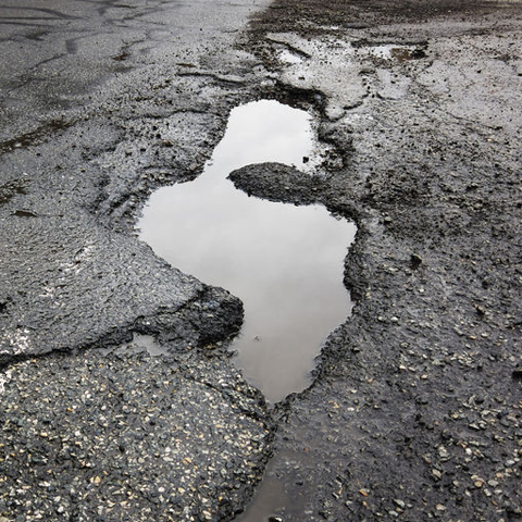 pothole in the road collecting water