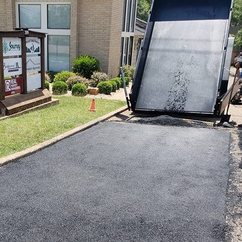 A Picture of Asphalt Being Applied On a Driveway.