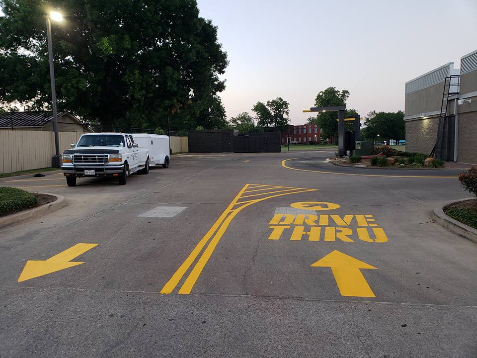 A Picture of a Yellow Drive Thru Painted On Ground.